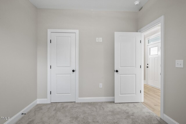 unfurnished bedroom with baseboards and carpet flooring