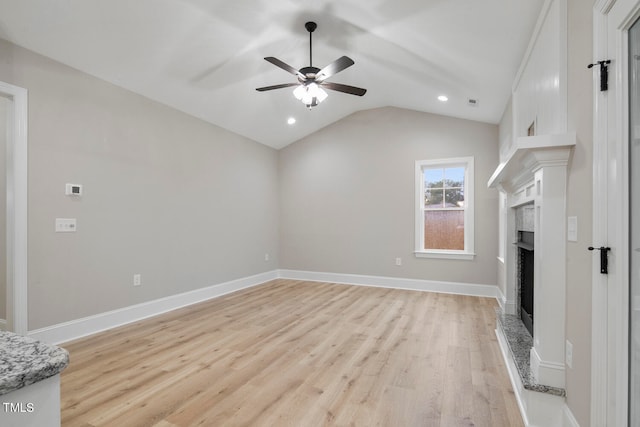 unfurnished living room with lofted ceiling, light wood-type flooring, and ceiling fan