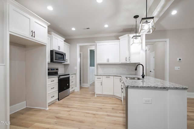 kitchen featuring sink, decorative light fixtures, light wood-type flooring, white cabinetry, and appliances with stainless steel finishes