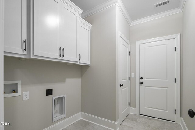 washroom with ornamental molding, hookup for an electric dryer, cabinet space, and visible vents