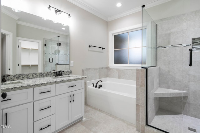 bathroom with vanity, crown molding, and separate shower and tub