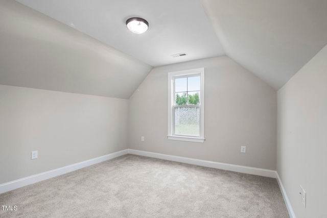 additional living space with carpet and vaulted ceiling