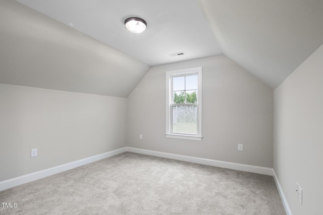 bonus room with vaulted ceiling, carpet, baseboards, and visible vents