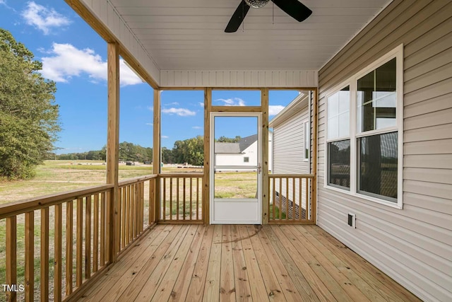 unfurnished sunroom featuring ceiling fan