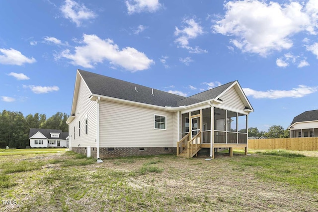 back of property with roof with shingles, a sunroom, fence, and crawl space