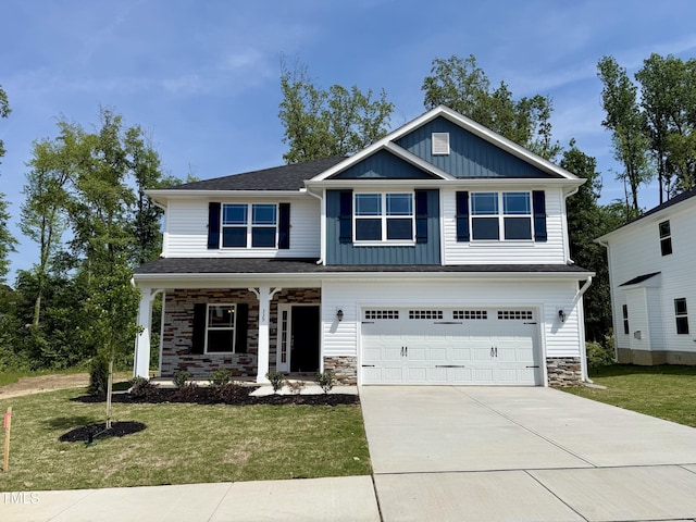 view of front facade featuring board and batten siding, a porch, and a front yard