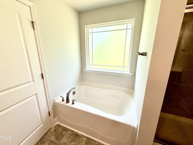 full bath featuring tiled shower and a garden tub