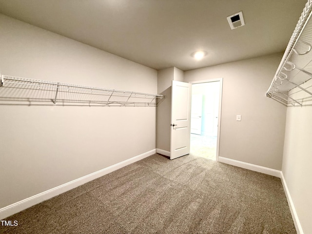 spacious closet with visible vents and carpet
