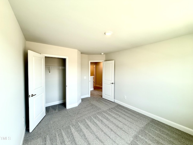 unfurnished bedroom featuring baseboards, a closet, and carpet floors