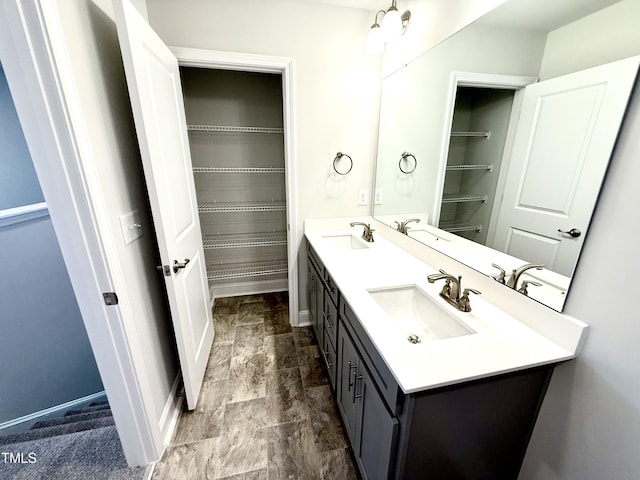 full bathroom with a sink and double vanity