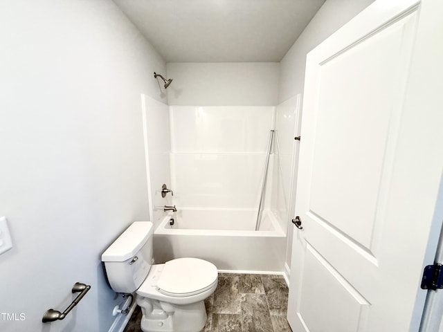 bathroom with toilet and shower / bathing tub combination