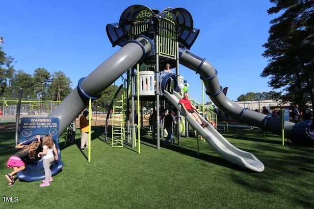 community jungle gym with a lawn