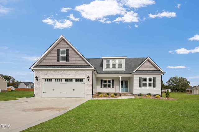 craftsman inspired home with a front yard and a garage