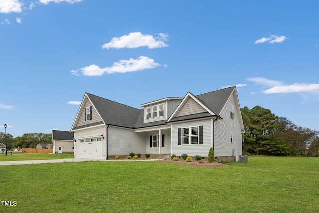 view of front facade featuring a garage, a front yard, and central AC