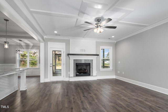 unfurnished living room with a wealth of natural light, crown molding, and dark hardwood / wood-style flooring