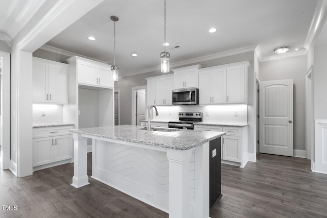 kitchen featuring white cabinets, sink, a kitchen island with sink, and appliances with stainless steel finishes