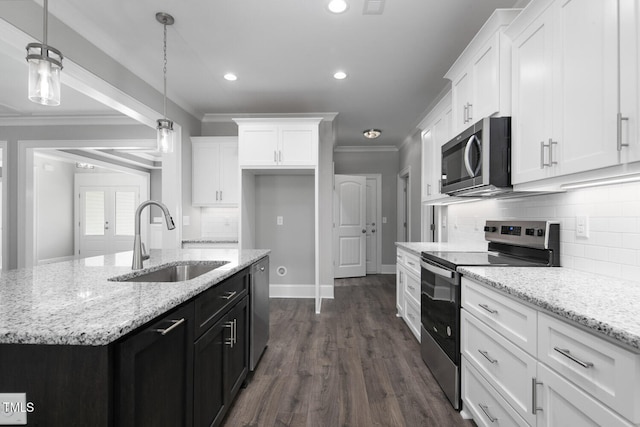 kitchen featuring a center island with sink, white cabinetry, appliances with stainless steel finishes, dark hardwood / wood-style floors, and pendant lighting