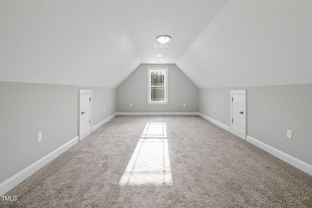 bonus room with lofted ceiling and carpet floors