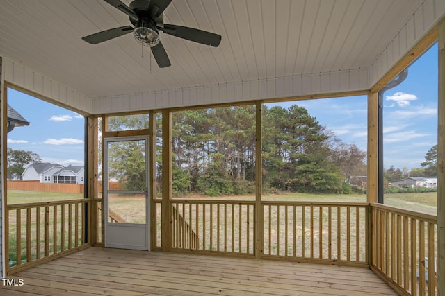 unfurnished sunroom featuring wooden ceiling, a wealth of natural light, and ceiling fan