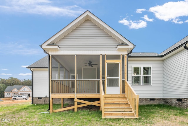 rear view of property featuring a sunroom and a lawn