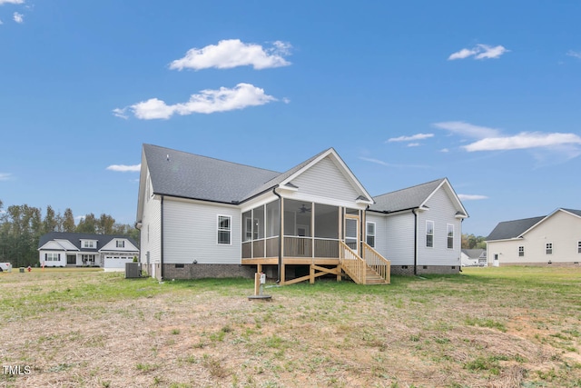 rear view of house with a yard, ceiling fan, a sunroom, and central AC