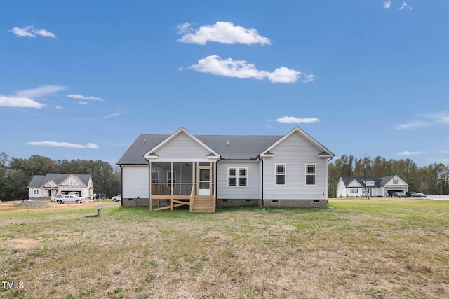 back of house featuring a sunroom and a yard