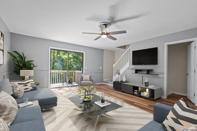 living room with light wood-type flooring and ceiling fan