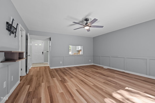 unfurnished living room featuring light hardwood / wood-style floors and ceiling fan