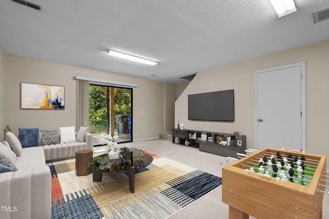 living room with carpet floors and a textured ceiling