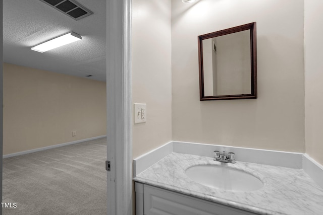 bathroom with vanity and a textured ceiling