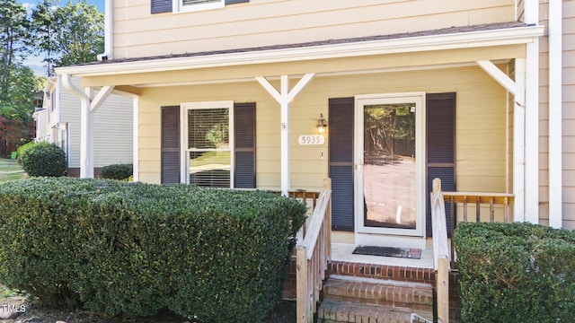 view of exterior entry with a porch