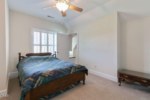 carpeted bedroom with ceiling fan and vaulted ceiling