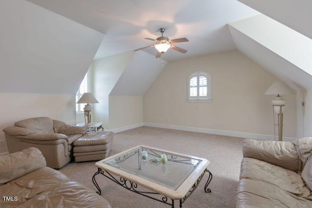 carpeted living room featuring lofted ceiling with skylight and ceiling fan