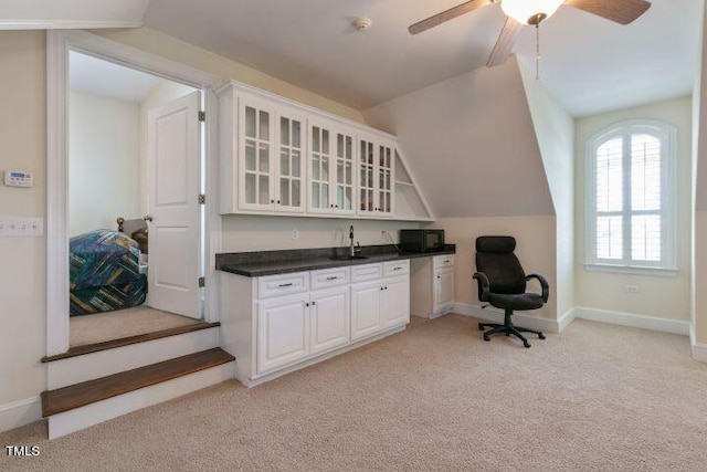 interior space with lofted ceiling, sink, and ceiling fan