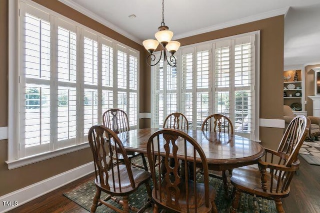 dining space featuring crown molding, an inviting chandelier, and dark hardwood / wood-style flooring