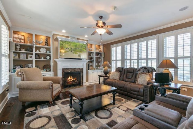 living room featuring crown molding, wood-type flooring, and a wealth of natural light