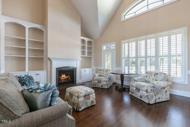 living room with high vaulted ceiling, a wealth of natural light, and dark hardwood / wood-style flooring