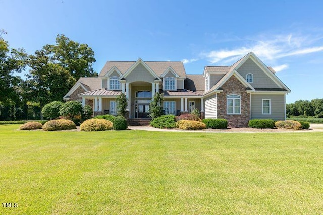 craftsman house featuring covered porch and a front lawn