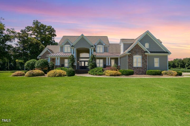 craftsman-style home with a lawn