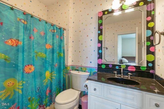 bathroom with vanity, toilet, and curtained shower