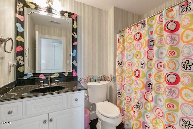 bathroom with vanity, a shower with shower curtain, and toilet