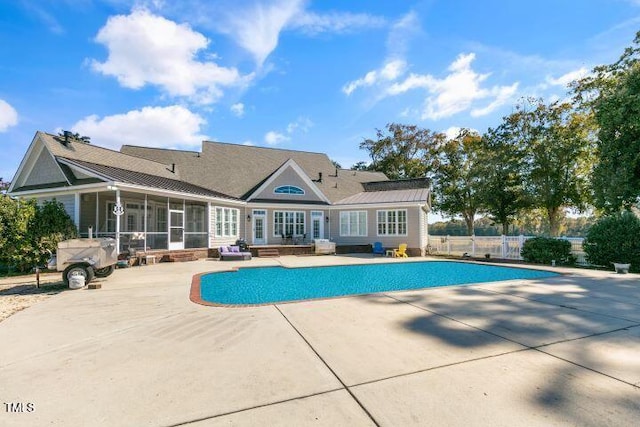 view of pool with a patio and a sunroom