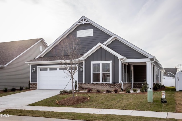 craftsman house with a garage and a front lawn