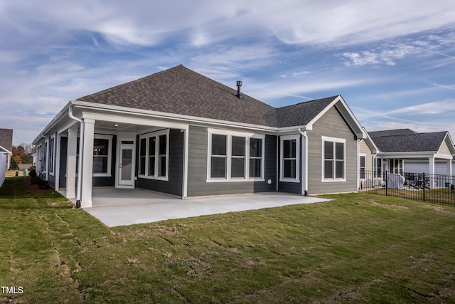 back of property featuring a lawn and a patio