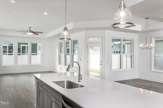 kitchen featuring decorative light fixtures, dark hardwood / wood-style floors, sink, and ceiling fan with notable chandelier