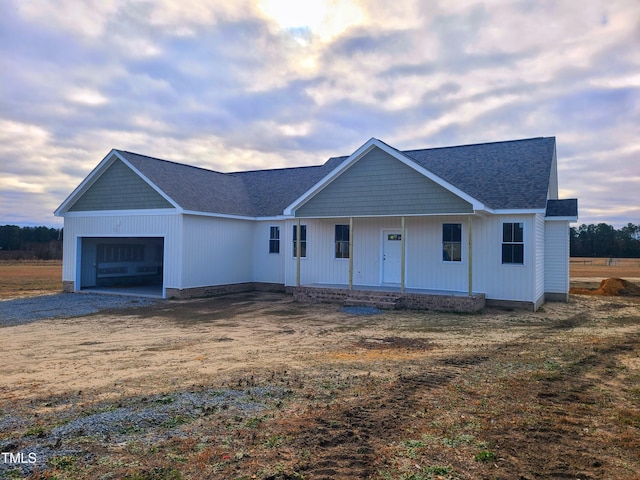 view of front of home with a porch and a garage