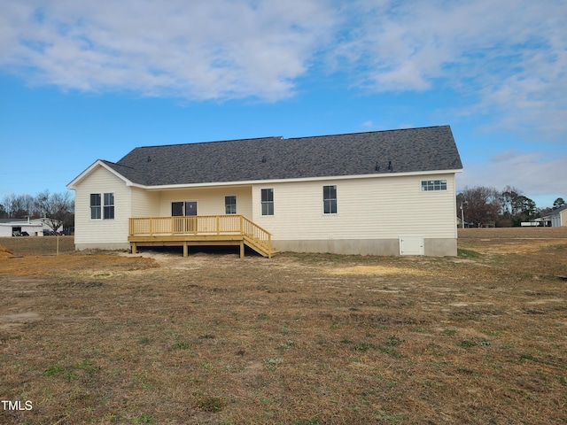 back of property with a lawn and a wooden deck