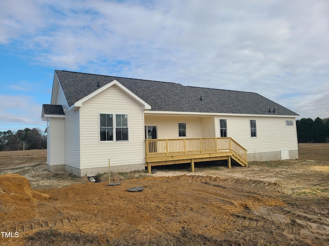 rear view of house featuring a deck