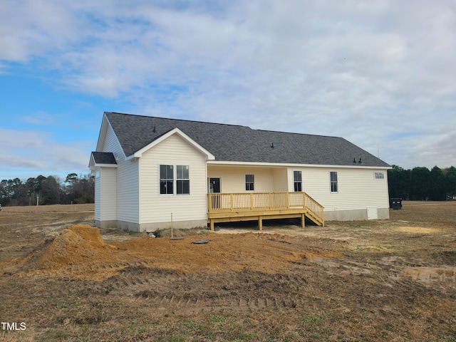 rear view of property with a wooden deck