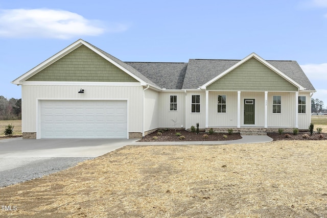 view of front of house featuring concrete driveway, covered porch, and a garage